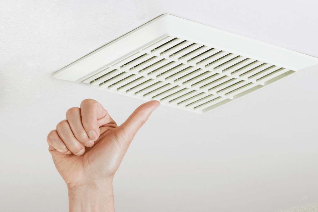 Thumb up showing satisfaction after bathroom exhaust fan replacement